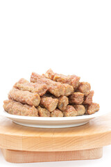 Meat kebabs on the plate with copy space above white background