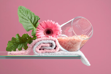 Spa composition with pink salt, Gerber, and towels.