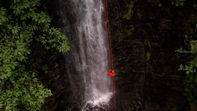 Aerial Footage of amateur rappelling down a waterfall 60fps