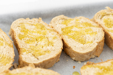 Baked bread with olive oil on the baking pan