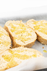 Baked bread with olive oil on the baking pan