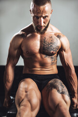 Fototapeta na wymiar Man Doing Training On Machine For His Leg Muscle At The Gym