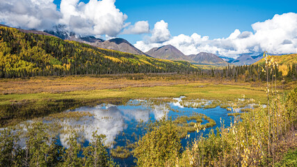 Road trip, tourism, travel themed shot heading directly towards huge mountain landscape in fall,...
