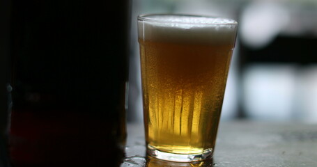 Person pouring beer into glass close-up, person serving alcoholic beverage and drinking