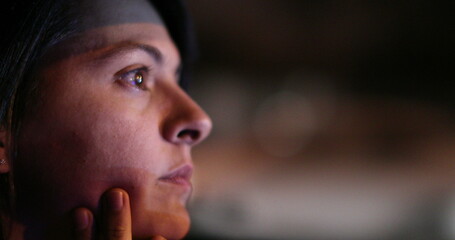 Pensive woman driving at night in city. Thoughtful portrait of female driver in evening