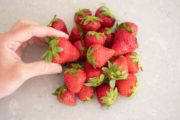 Fresh red strawberries on a marble tabletop in the kitchen. Harvest from the garden.