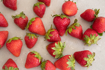 Fresh red strawberries on a marble tabletop in the kitchen. Harvest from the garden.