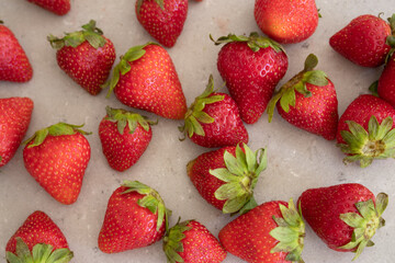 Fresh red strawberries on a marble tabletop in the kitchen. Harvest from the garden.