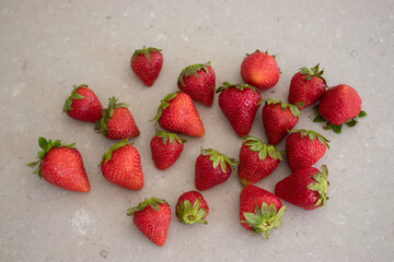 Fresh red strawberries on a marble tabletop in the kitchen. Harvest from the garden.