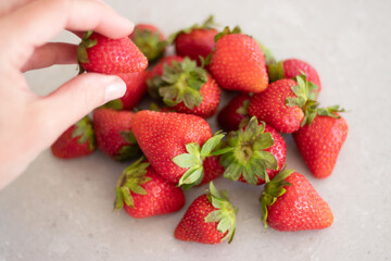 Fresh red strawberries on a marble tabletop in the kitchen. Harvest from the garden.