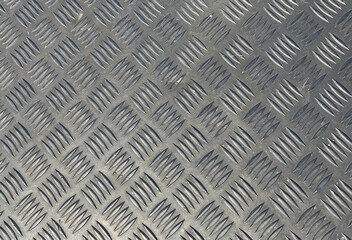 metal texture. voluminous background with convex notches of a square shape. background, gray metal with splashes of rust