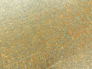 texture, orange tiles on the floor. tiles made of ceramic, concrete materials. on a tile colored stones in a rectangular shape. background, natural texture