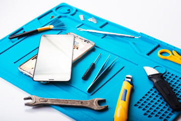 Flat lay image of dismantling the broken smart phone for preparing to repair or replace some...