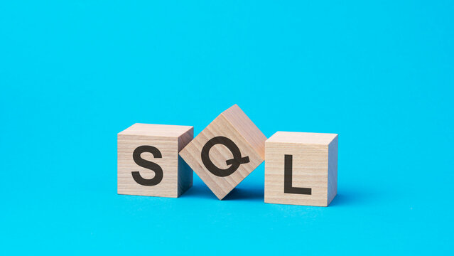 sql text on wooden blocks, business concept, blue background