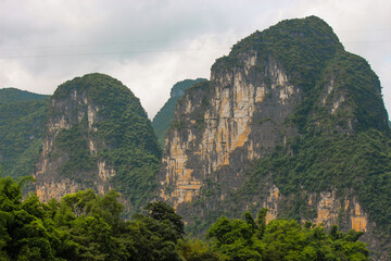 landscape photography of the mountains that are on the side of the li river in the guilin region in...
