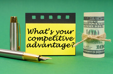On a green surface, a dollars, a notepad and yellow stickers with the inscription - What is Your...