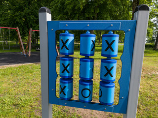 Children's playground with Tic Tac Toe game in summer day.