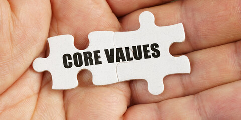 In the hand of a man are puzzles with the inscription - CORE VALUES