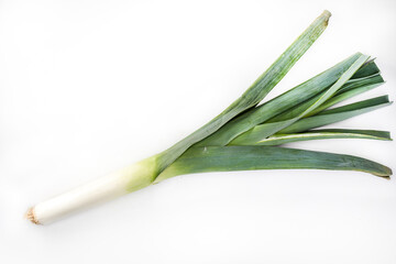 A leek on a white background. Green spring vegetables, isolated. Packshot photo, horizontal view with a copy space.