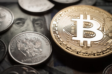 Bitcoin Crypto currency coin virtual money and Russian rubles on dollars banknotes.