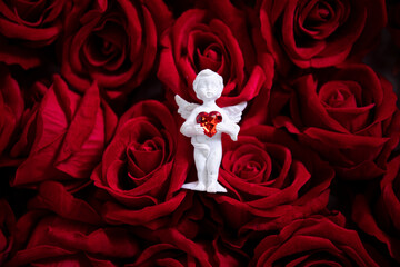 red rose petals. Angel statue. 