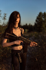 Fototapeta na wymiar Girl with a gun in her hands