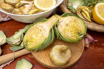 Cooking of green heads of artichokes plants, how to peel artichoke