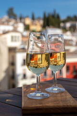 Tasting of Spanish sweet and dry fortified Vino de Jerez sherry wine with view on roofs and houses of old andalusian town