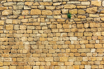 background, texture - a wall of rough blocks, with cracks between stones