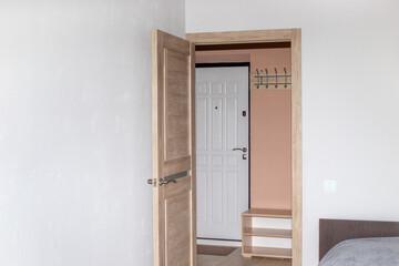 The door from the bedroom to the hallway in a small bright apartment. Room interior