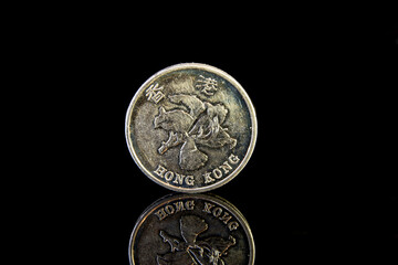 Hong Kong 5 Dollar Coin with reflection off a shiny black surface