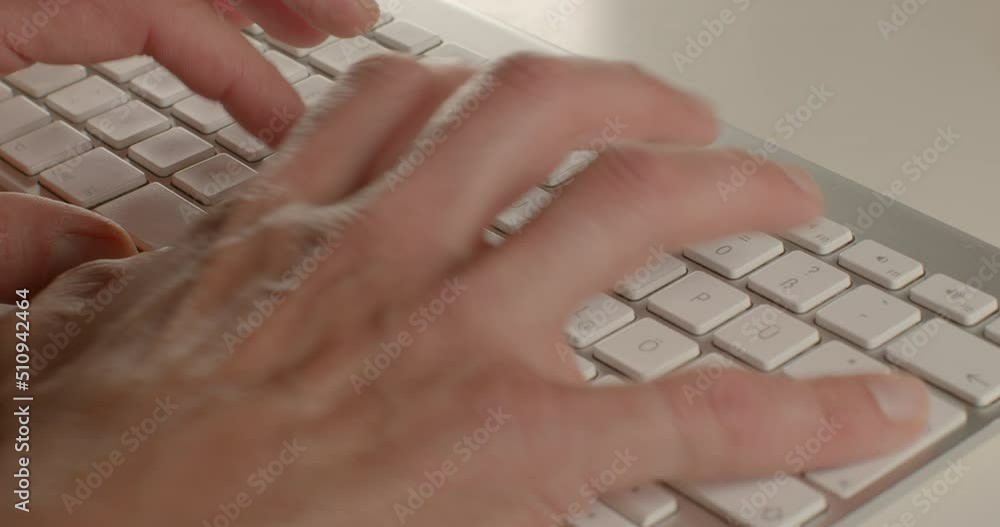 Poster close-up of a man's hand typing on a keyboard on a white table. he is typing. using electronic text 