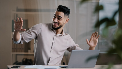  Happy funny male arabic businessman hispanic young guy millennial smiling man active dancing at...