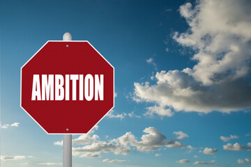 Obraz premium Red stop sign with the word Ambition on a blue sky background.