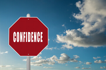 Red stop sign with the word Confidence on a blue sky background.