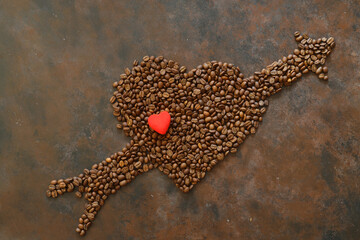Obraz premium Roasted coffee beans in heart shaped bowl on dark background. Love coffee concept. Top view flat lay with copy space