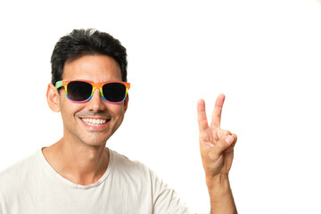 Naklejka premium Brunette boy smiling with rainbow lgbtq glasses on white background