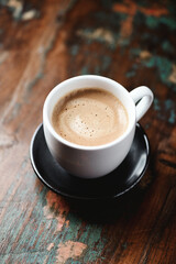 Cup of coffee on wooden background. Close up.	