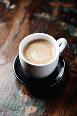 Cup of coffee on wooden background. Close up.	