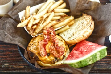 Cheesse burger with becon, french frie and watermelon