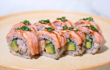 Closeup sliced shrimp, salmon, avocado and green onion rolls, selective focus
