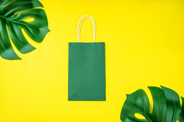 Eco-friendly paper bags on yellow background.Recycled paper shopping bag with green leaves .Set of...