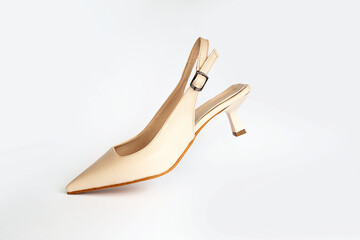 Beige short heels isolated on white background. Fashion concept, catwalk. A modern and trendy shoe store.