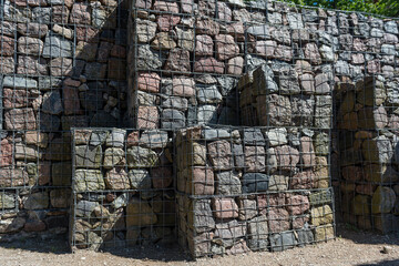 Retaining wall gabion baskets, Gabion wall caged stones textured background. Gabion wall caged stones.