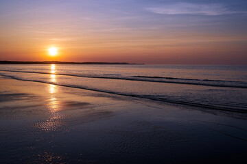 Fototapeta na wymiar sunset on a sandy beach on the Baltic sea in the evening