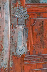 Old door with elaborate antique handle. - 510947489