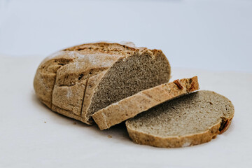 Homemade freshly baked rye and wheat loaf of bread on white background. Concept of health and huger. Organic Food concept, photo  with copy space, close up