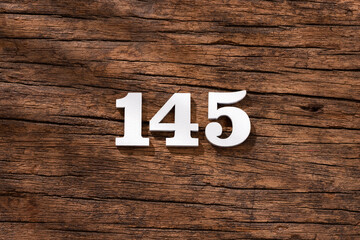 Number 145 in wood, isolated on rustic background