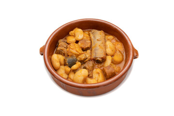 A terracotta plate with Asturian fabada, a typical Spanish bean stew, on a white background. Spanish food concept.