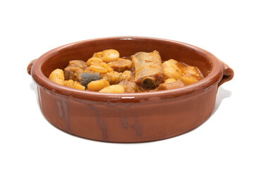 A terracotta plate with Asturian fabada, a typical Spanish bean stew, on a white background. Spanish food concept.